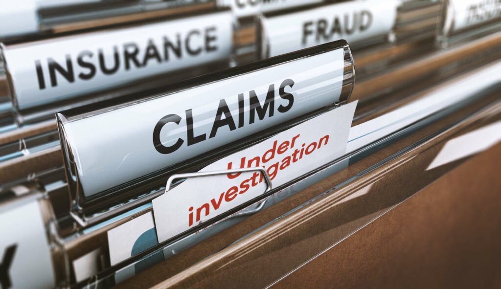 File folders in a drawer are labeled "INSURANCE," "CLAIMS," "FRAUD," and "Under investigation." A paper labeled "Under investigation" is partially visible within the "CLAIMS" folder, hinting at a complex case involving the plastic surgery business.