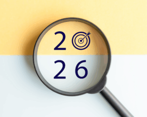 A magnifying glass highlights the numbers "2026" with a target symbol replacing the zero, set against a yellow and white background—symbolizing the 2026 M&A Market outlook for business owners.